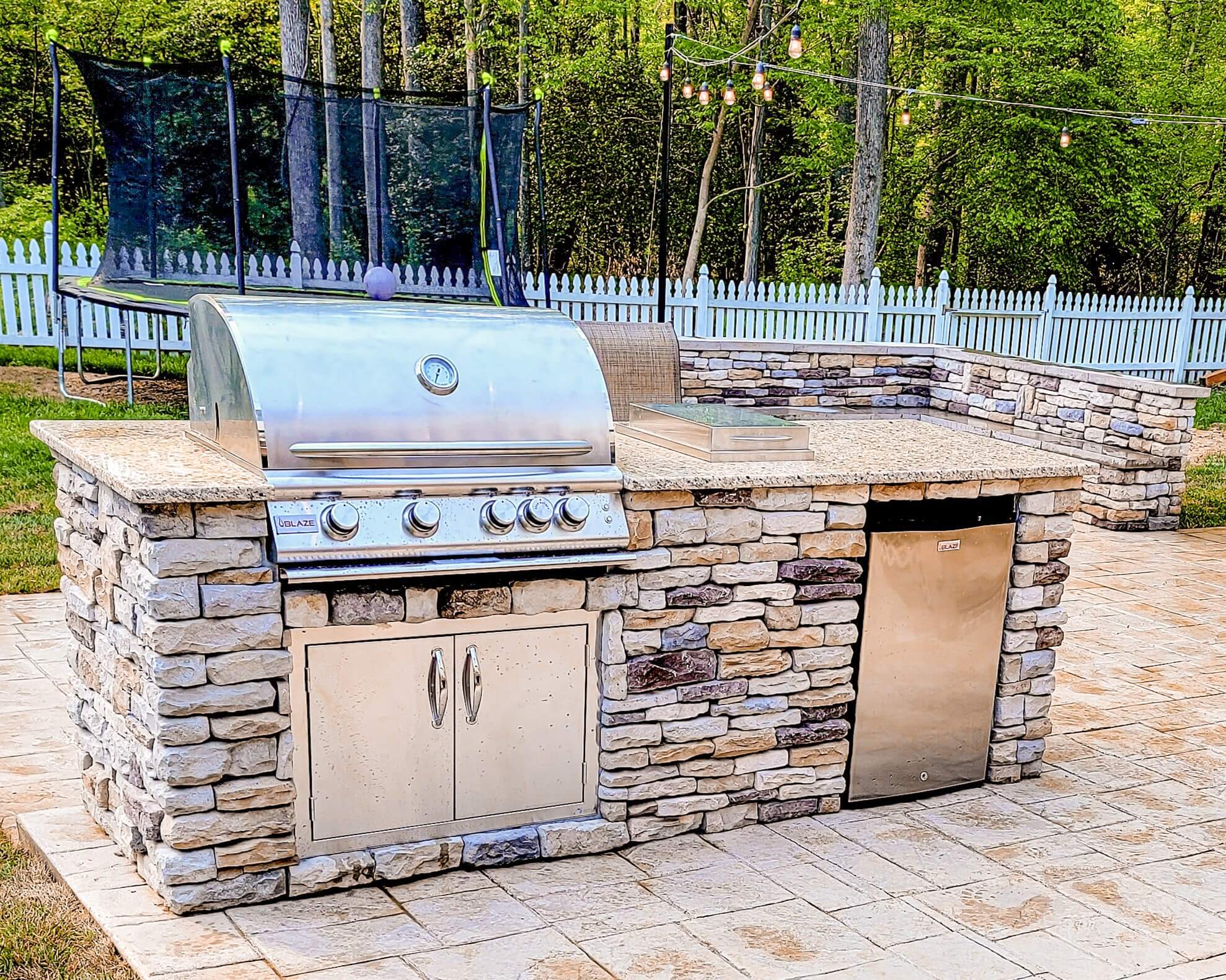 custom outdoor kitchen with grill and patio.